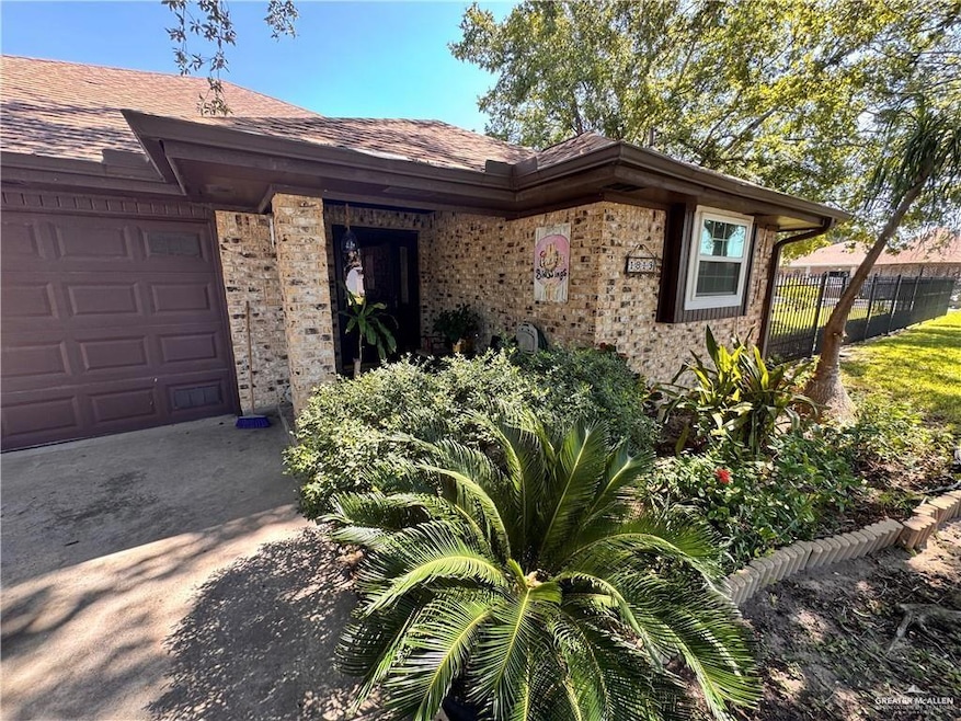 Property entrance with brick siding and roof with shingles