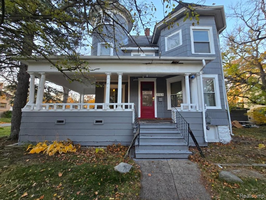 View of front facade featuring a porch and a chimney