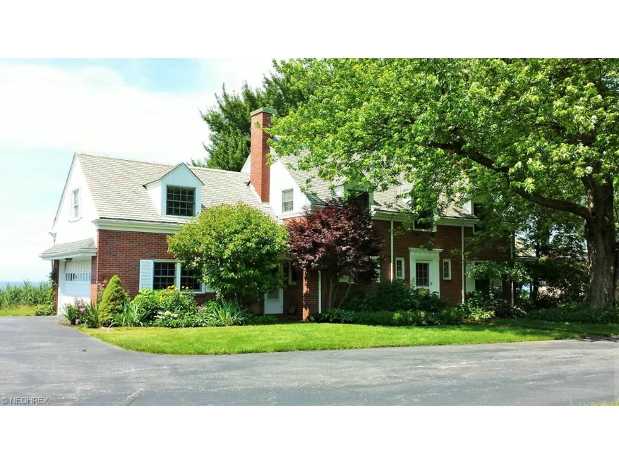 Classic brick French Colonial perched on the shore