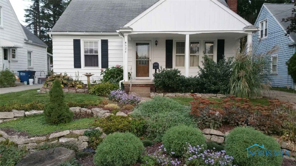Front elevation shows luxurious easy-care landscap