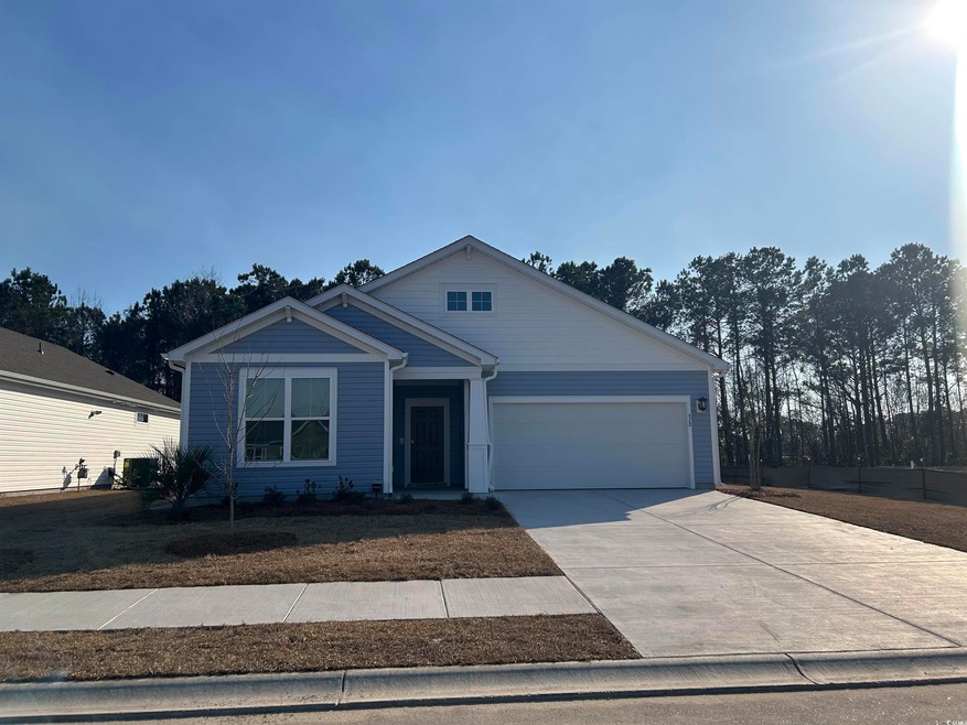 View of front of property with a garage and concre