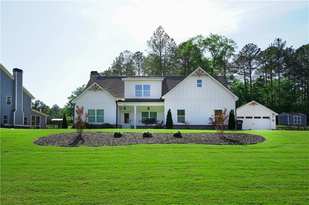 Modern farmhouse featuring an outdoor structure, a