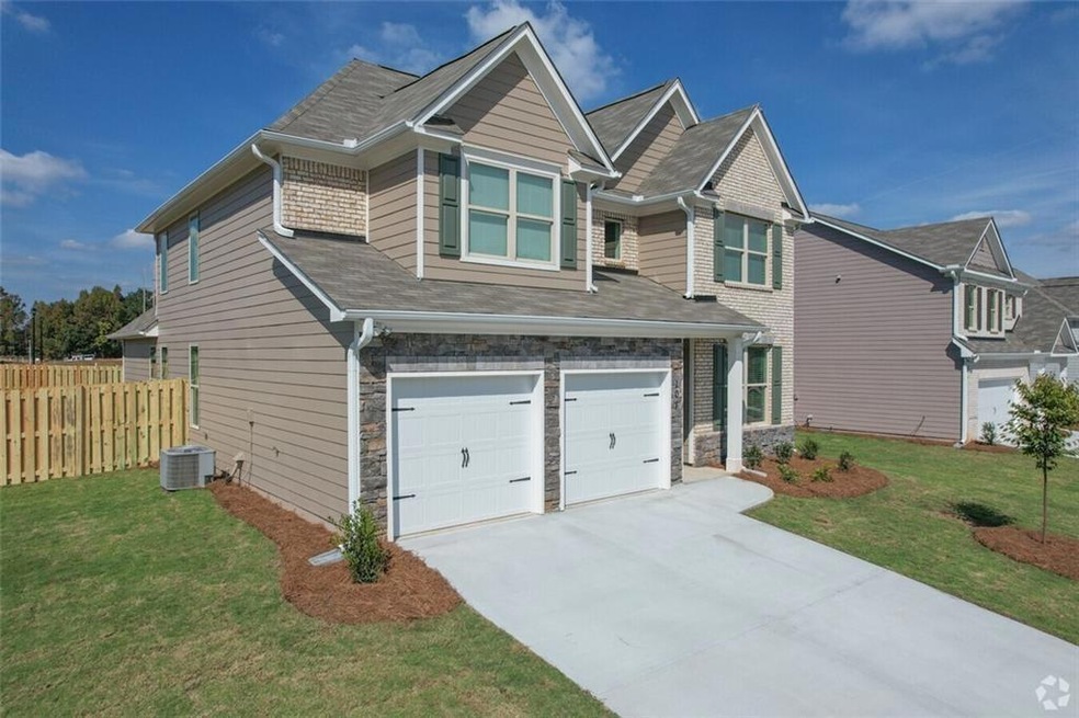 Craftsman-style home featuring a garage, central a