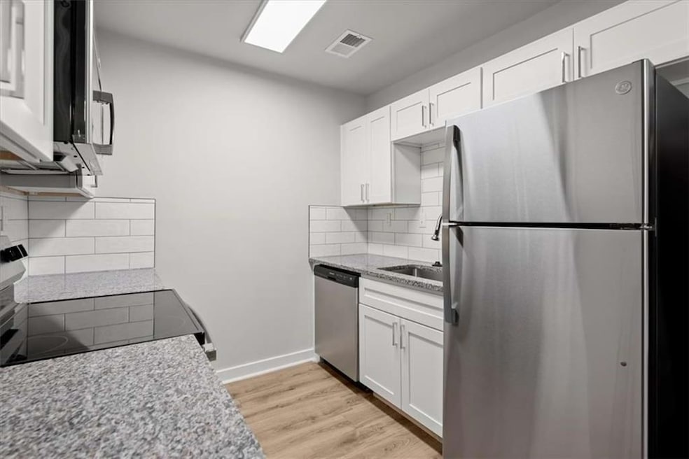 Kitchen with stainless steel appliances, visible v