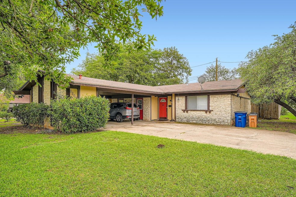 Ranch-style house with stone siding, a front lawn