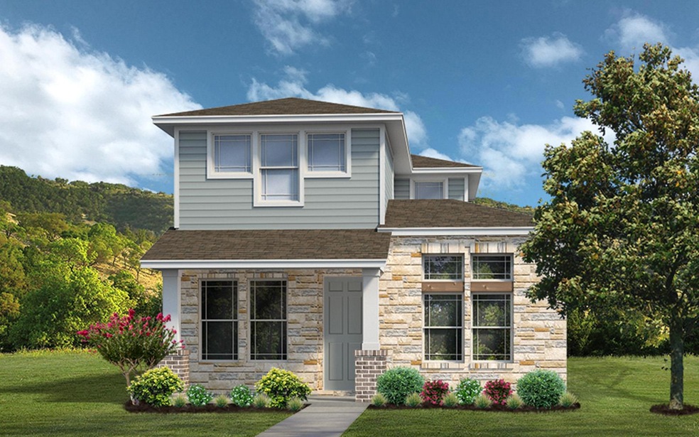 View of front of home with a front yard, stone si