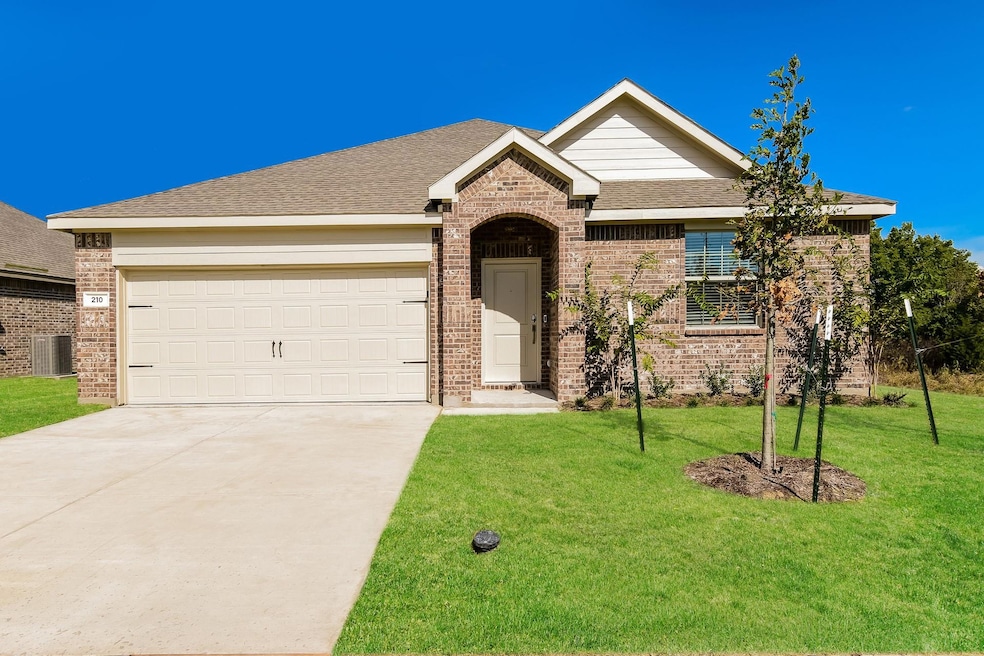 Ranch-style home with a front yard, central air condition unit, and a garage
