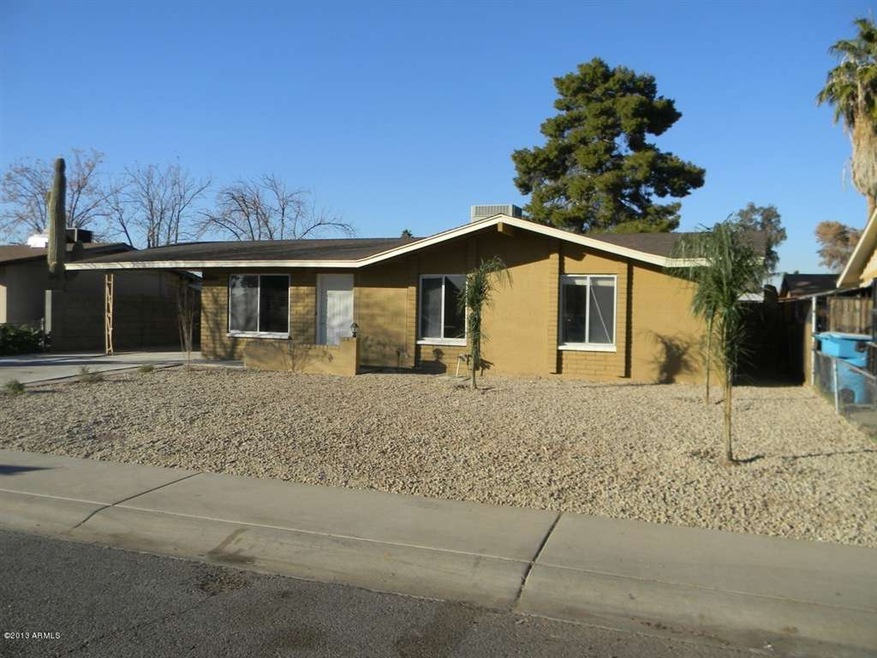 Front of home with desert landscape