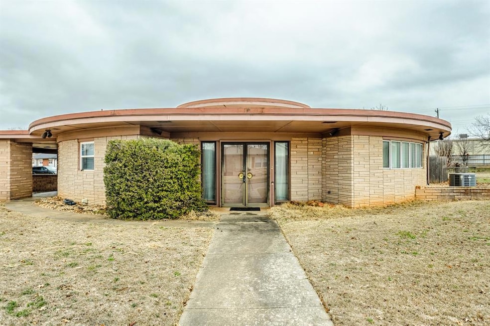 View of front of home featuring stone siding and cooling unit