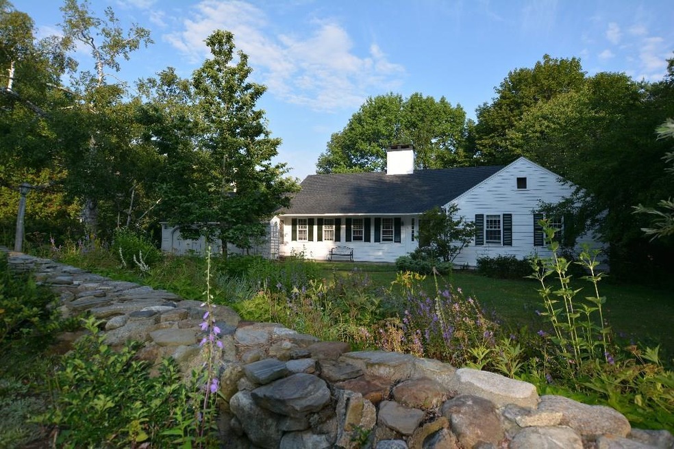 Nestled on a large corner lot, this...