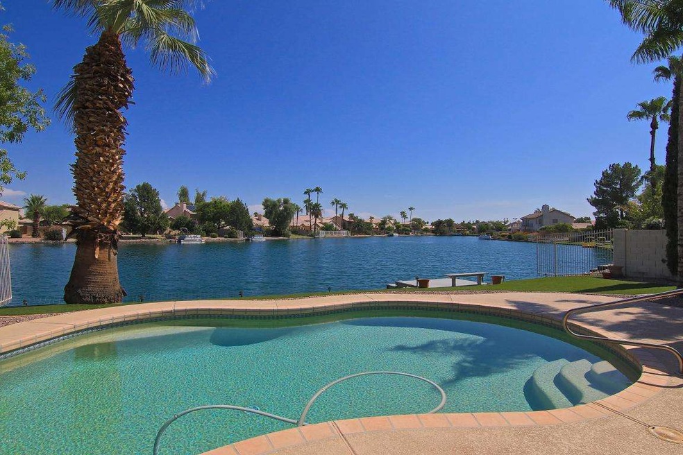 lake view with pool and dock