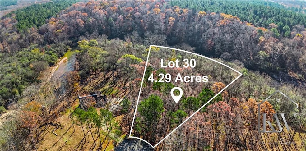 Aerial view featuring a wooded view