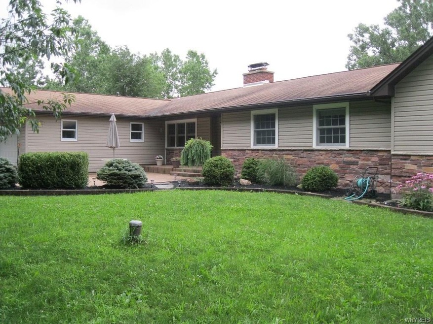 Vinyl and stone ranch on secluded acreage.
