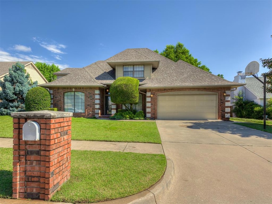View of front of house with roof with shingles, brick siding, an attached garage, driveway, and a front lawn