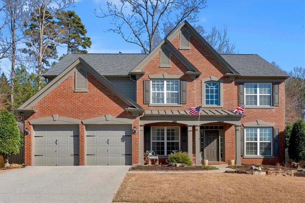 View of front facade featuring a garage, driveway,