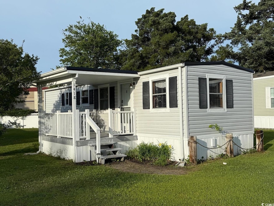 Back of property featuring a yard