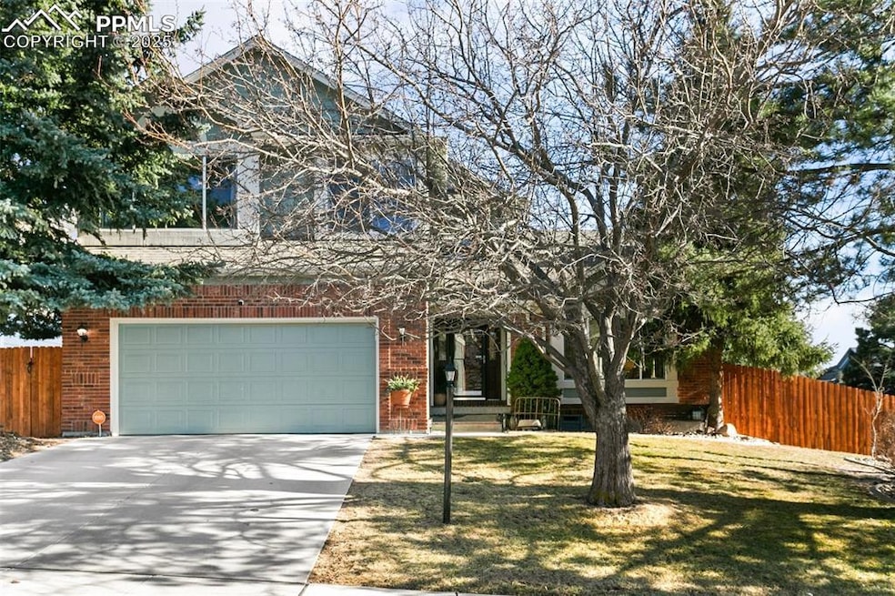 View of front of home featuring fence, a front law