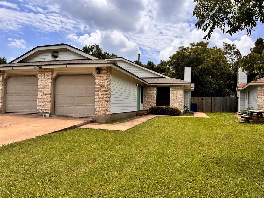 Ranch-style home with a garage, driveway, and a c