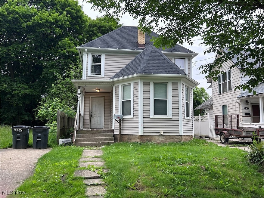 Victorian home featuring roof with shingles