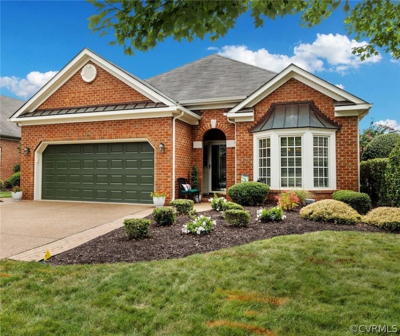 View of front facade with a garage and a front law