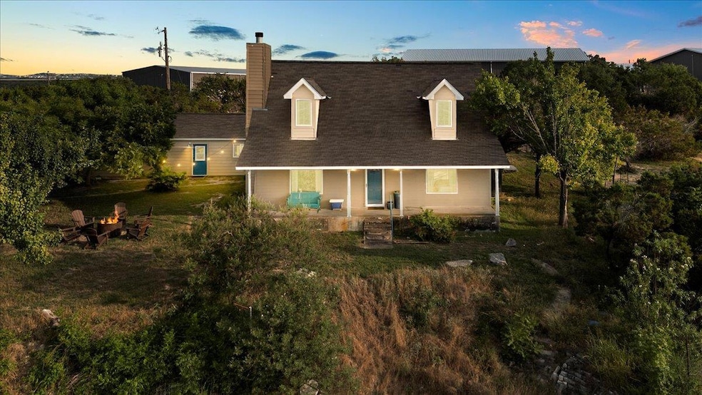 View of front of property featuring a chimney, co