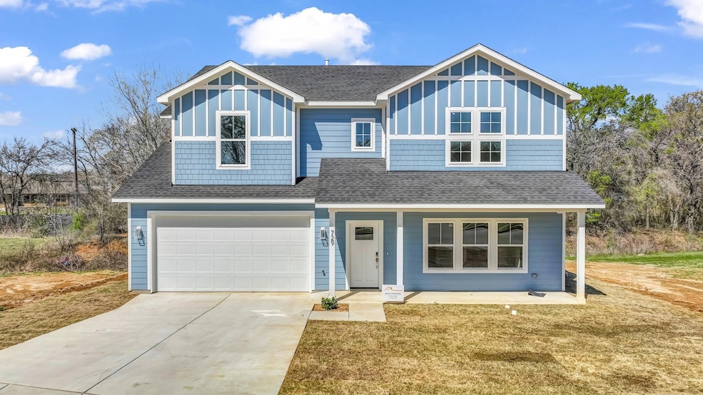 View of front of property featuring driveway, cove