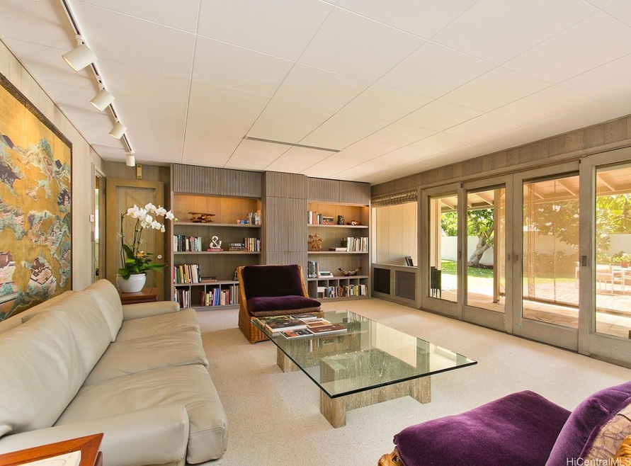 Formal living room with sliders to red brick patio