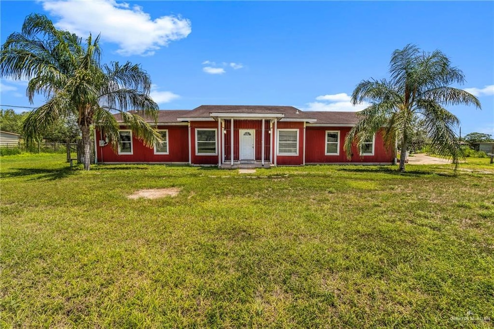 Single story home with a front lawn and covered porch