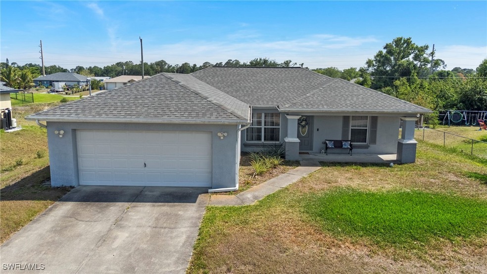 Single story home with a front lawn, concrete driv
