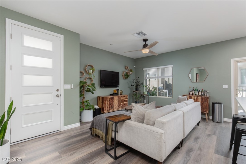 Living room featuring visible vents, baseboards, c