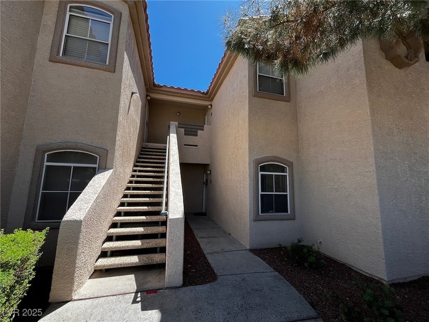 Entrance to property with stucco siding and a tile