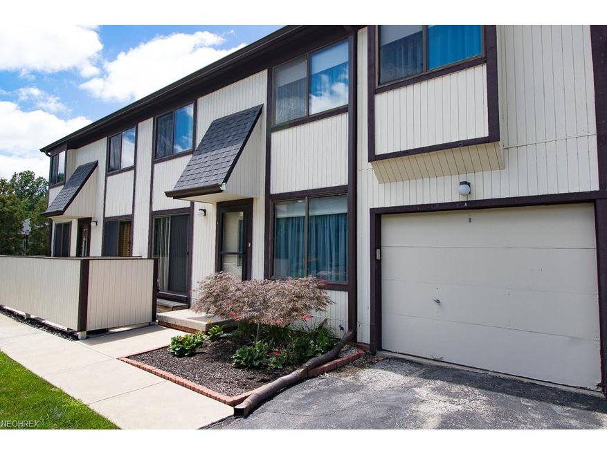 Front Elevation with private patio and 1 car Garag