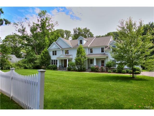 Picket fencing enhances the front facade of this l