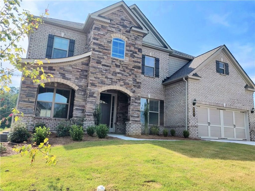 Beautiful elevation that includes a two story ston