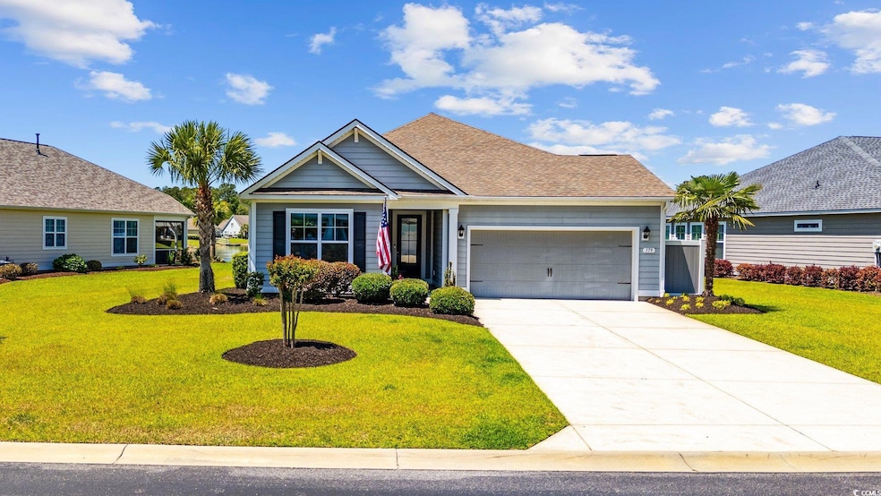 View of front facade with an attached garage, a fr