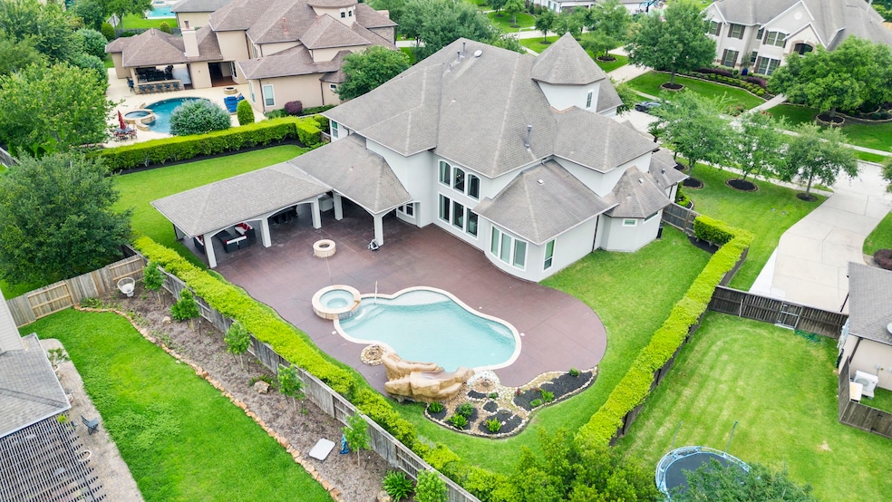 Large 40 x 16 covered patio with views of the gas fire pit, hot tub, salt water pool and rock slide