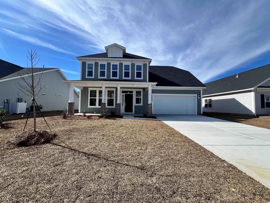 View of front facade with a porch and a garage