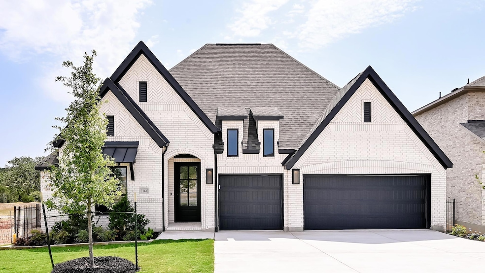French country style house with concrete driveway