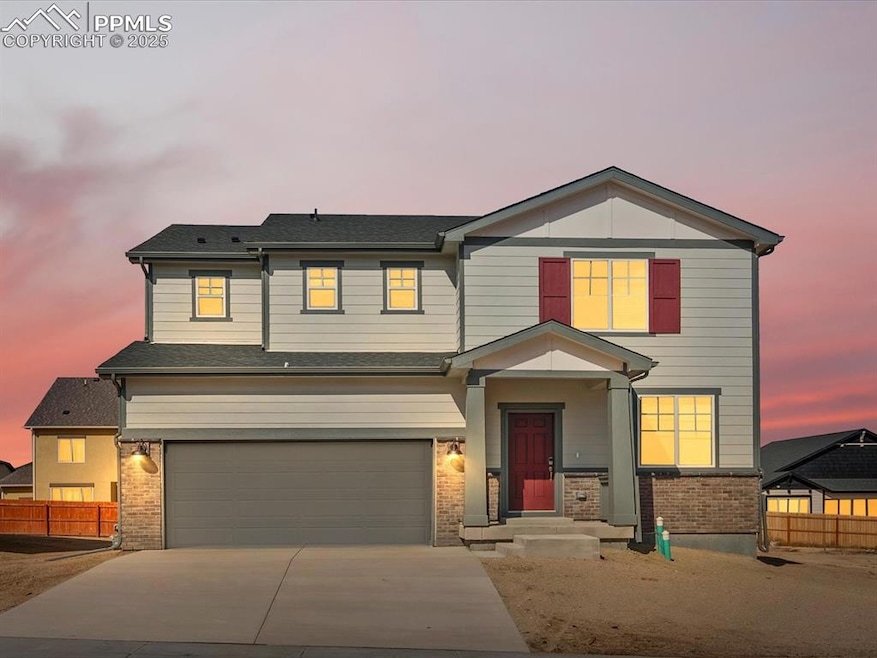 View of front of house featuring brick siding, a garage, driveway, and a shingled roof