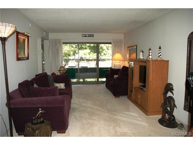 Living room with newer carpet and triple sliders t