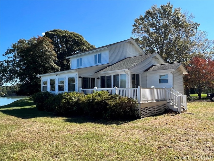 Back of house featuring a yard and a deck