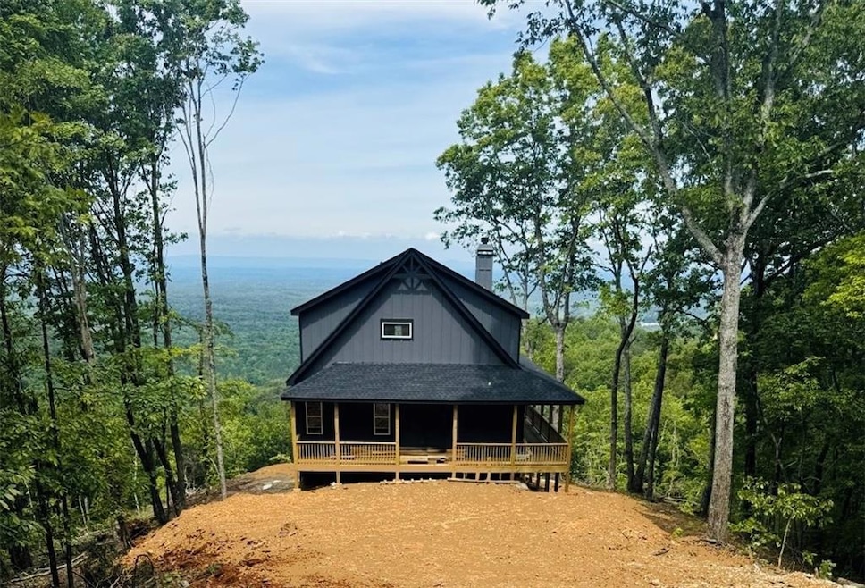 View of front facade with covered porch and a chimney