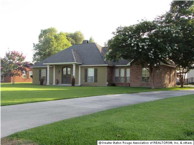 Lovely front view of home with paved driveway.