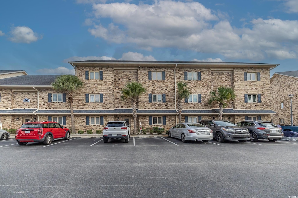 View of property with uncovered parking