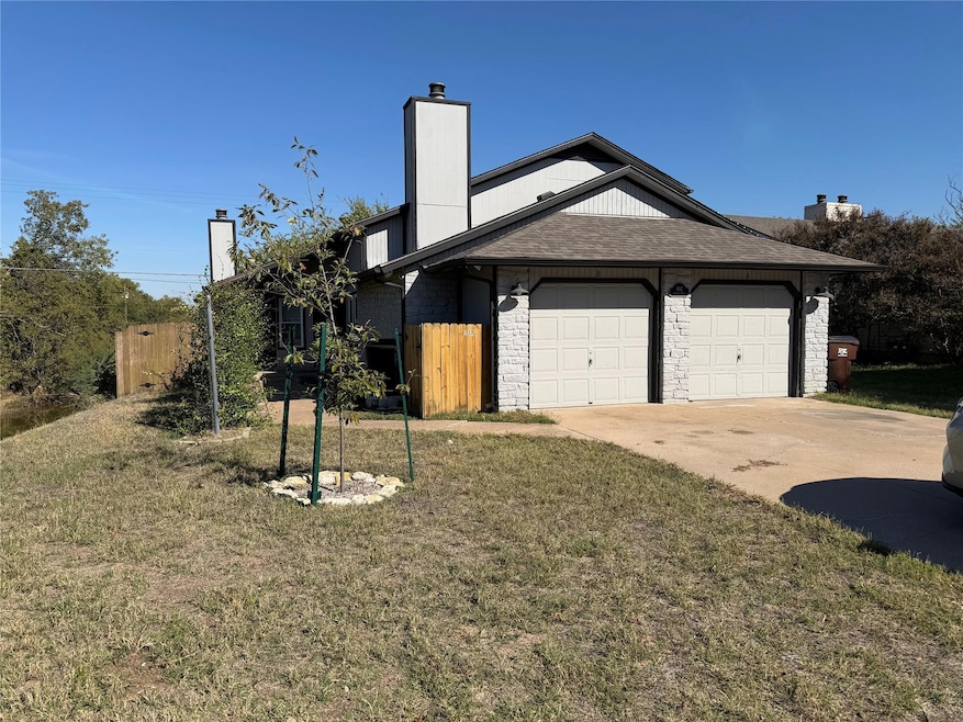View of side of home featuring concrete driveway,