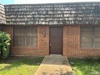 Doorway to property with brick siding