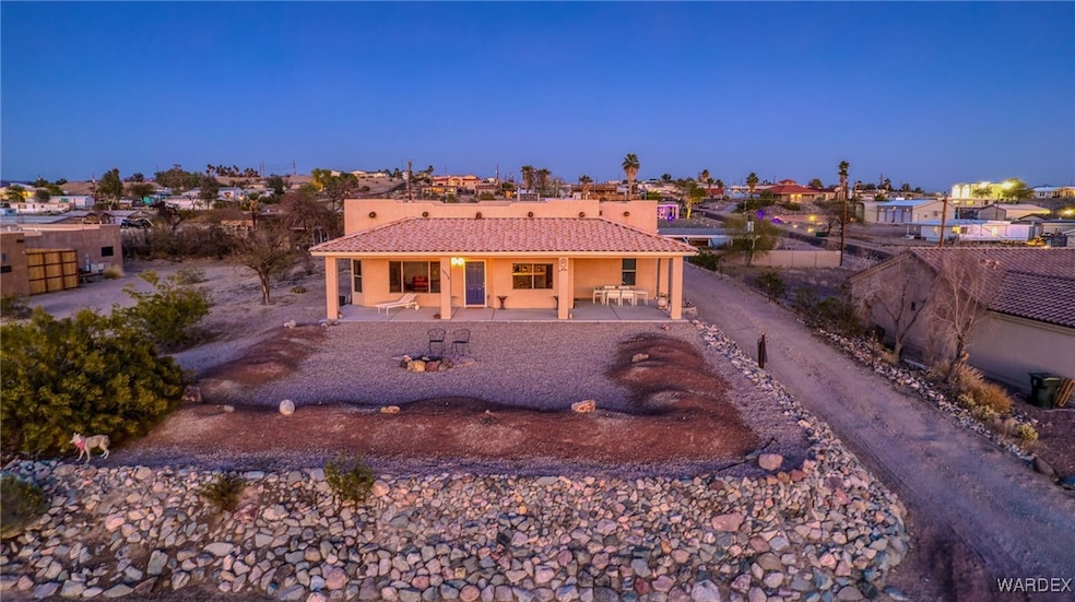 View of front of property with stucco siding, a pa