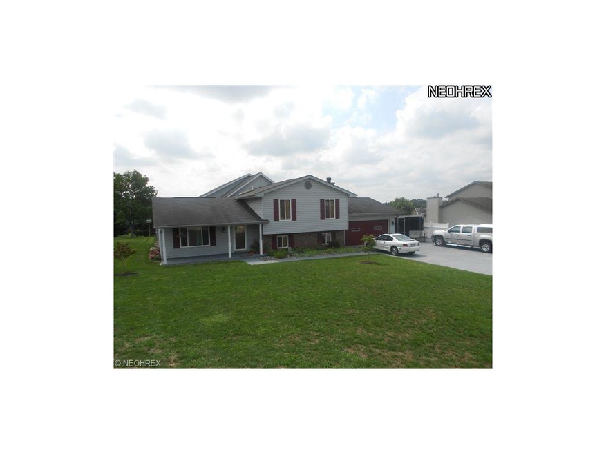Front view with 3 car wide driveway