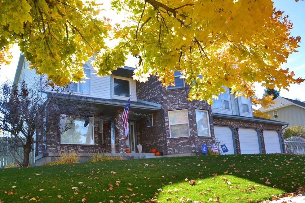 View of front of property with a garage and a front yard