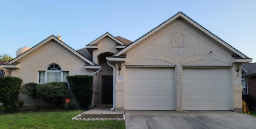 Ranch-style home with driveway and a garage